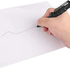 A hand is using a black tactical self-defense pen with a glass breaker tip to draw a line on a white piece of paper.