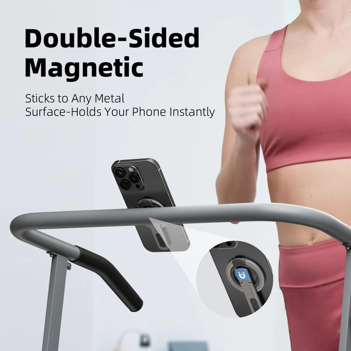Un soutien-gorge de sport rose tient un smartphone sur une barre de gym grise avec un support magnétique double face.