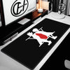 Black gaming mouse pad featuring a white and red silhouette of a character on a white desk.