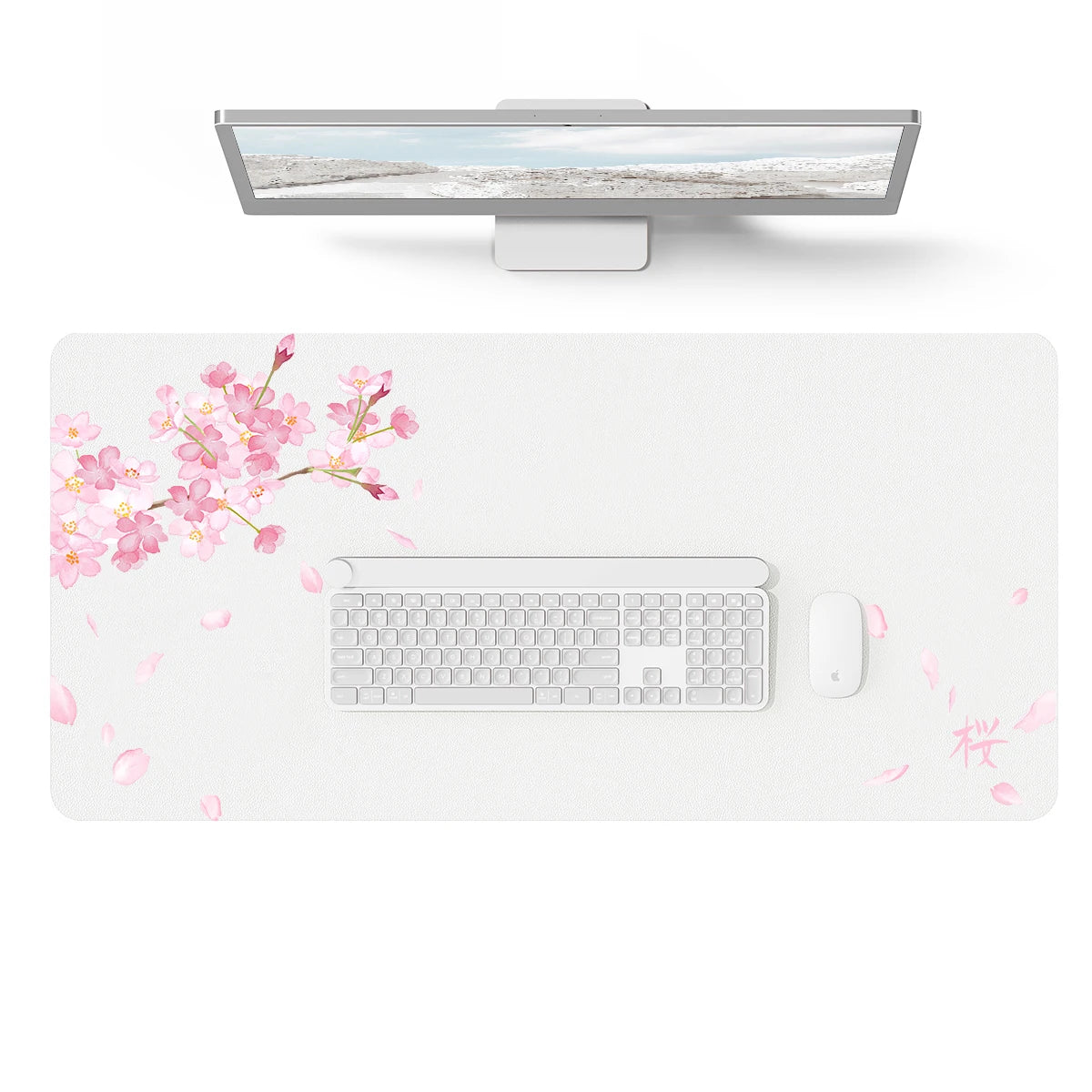 A large gray PU leather desk mat is shown with a laptop and keyboard placed on it, surrounded by pink cherry blossoms.