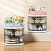 A clear acrylic desktop pen holder with pink accents holds various pens, pencils, and stationery items.