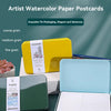 A set of artist watercolor paper postcards in tin packaging showing various grain textures.