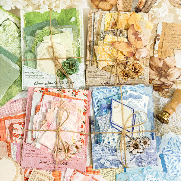 A collection of vintage paper craft materials including cards, leaves, and floral elements for scrapbooking.