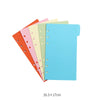 A stack of colorful A6 budget planner binders with envelope pockets and expense sheets