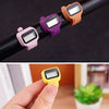 A hand holds a colorful thumb tally counter with a yellow display, demonstrating its use.