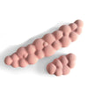 A pink ergonomic memory foam wrist rest pad for desk and mouse, shown in profile.
