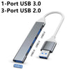 A silver USB hub adapter with a long cable, featuring one USB 3.0 port and three USB 2.0 ports.
