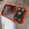 An orange clear shockproof case with multiple camera lenses protecting an iPhone is held in a hand.