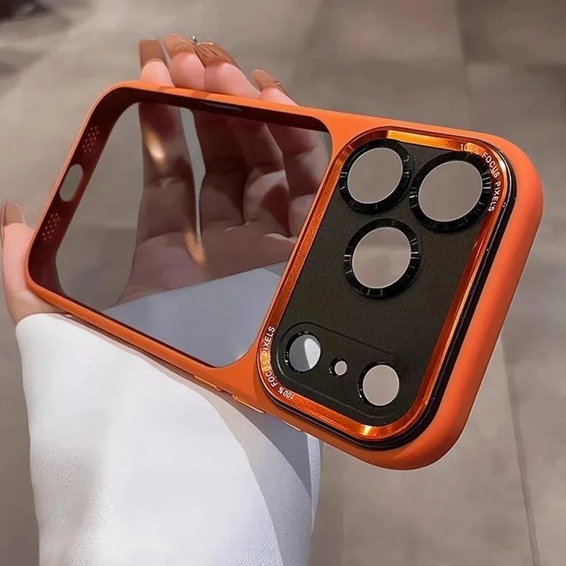 An orange clear shockproof case with multiple camera lenses protecting an iPhone is held in a hand.