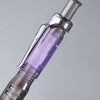 A close-up of an iridescent purple pen body with a clear tip, highlighting its built-in structure.