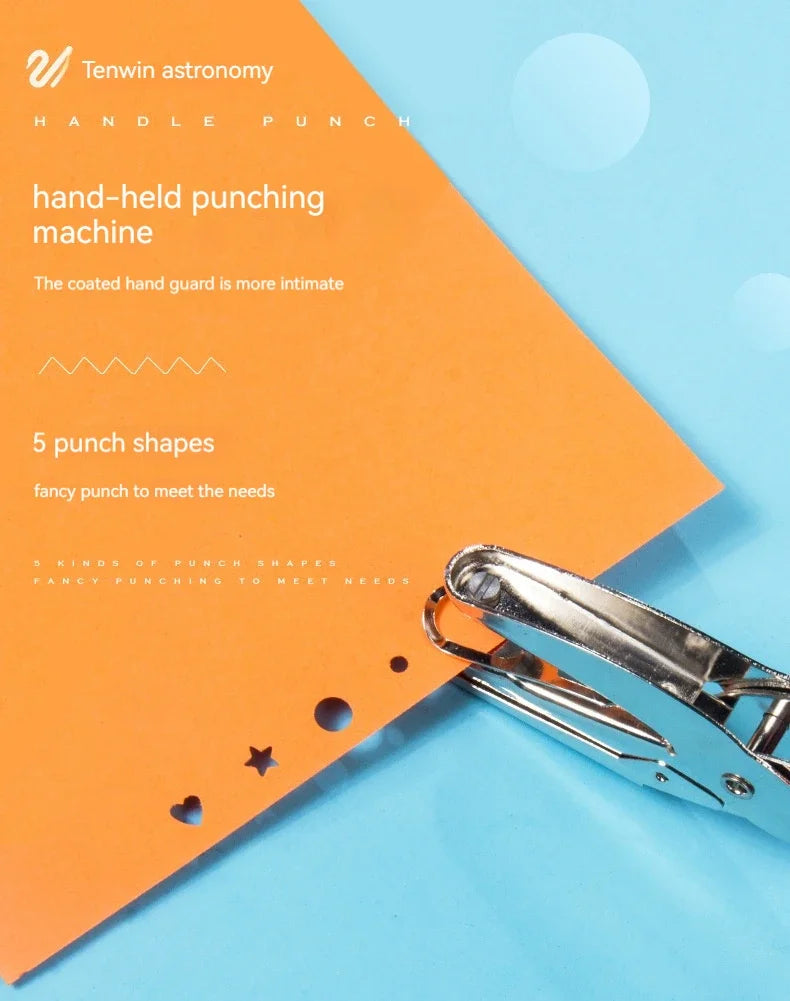 A close-up of a silver handheld punching machine with various punch shapes resting on an orange background.