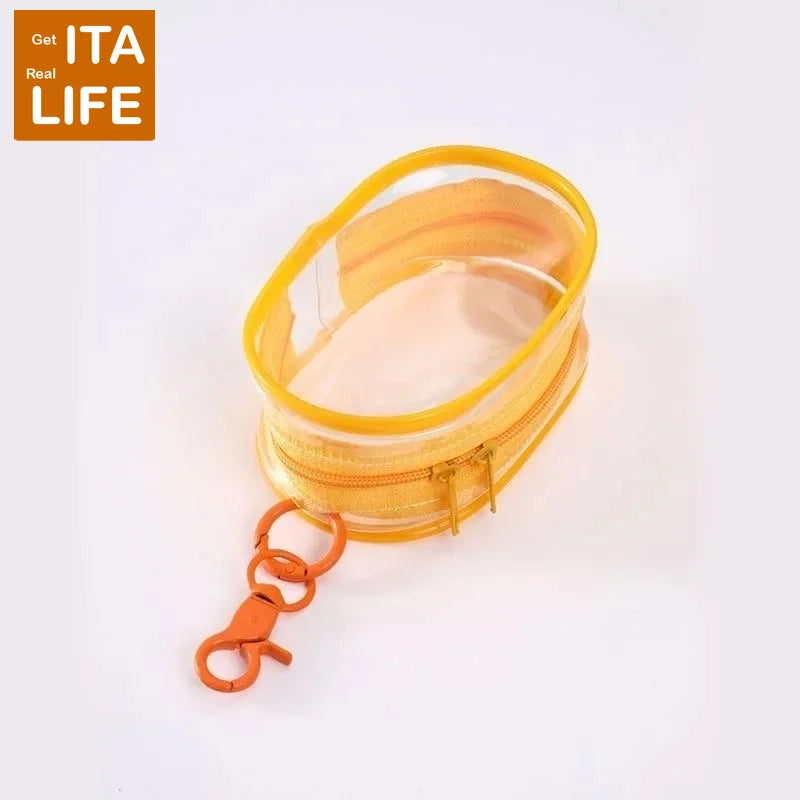 A small clear yellow bag with a zipper and an orange keychain attached.
