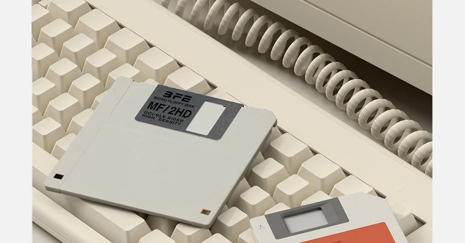 A silver M.2 NVMe SSD in an enclosure is shown resting on a grid of plastic blocks next to a coiled cable.