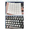 A hand holds a sheet of transparent silicone keyboard stickers for long nails, showing the product layout.