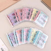A set of clear plastic budget binders for savings challenges featuring pink, purple, and blue accents.