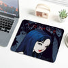 A dark blue and black illustration of Tomie from Junji Ito featured on a mouse pad.