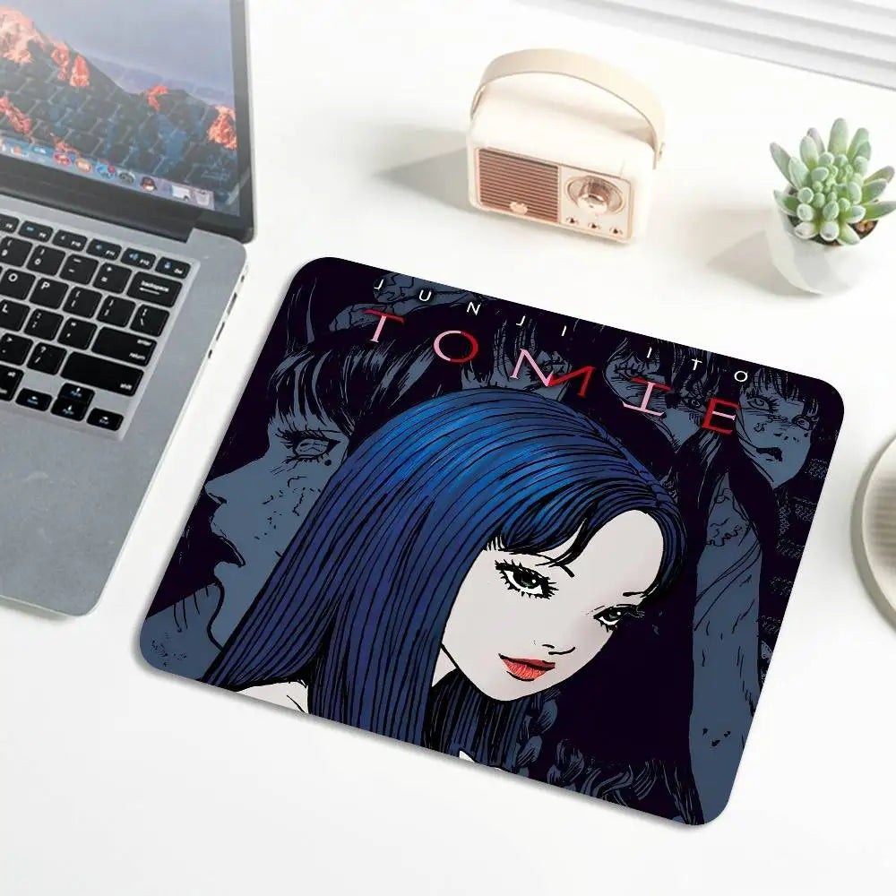 A dark blue and black illustration of Tomie from Junji Ito featured on a mouse pad.
