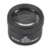 A black precision 30x handheld magnifying loupe with a round lens and textured body.