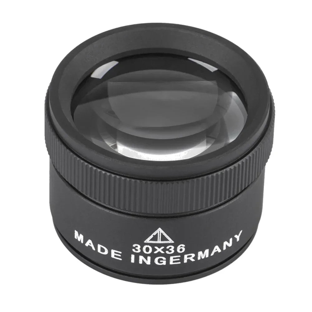 A black precision 30x handheld magnifying loupe with a round lens and textured body.