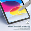 A close-up view of a tablet screen showing colorful graphics and a glass screen protector being applied.