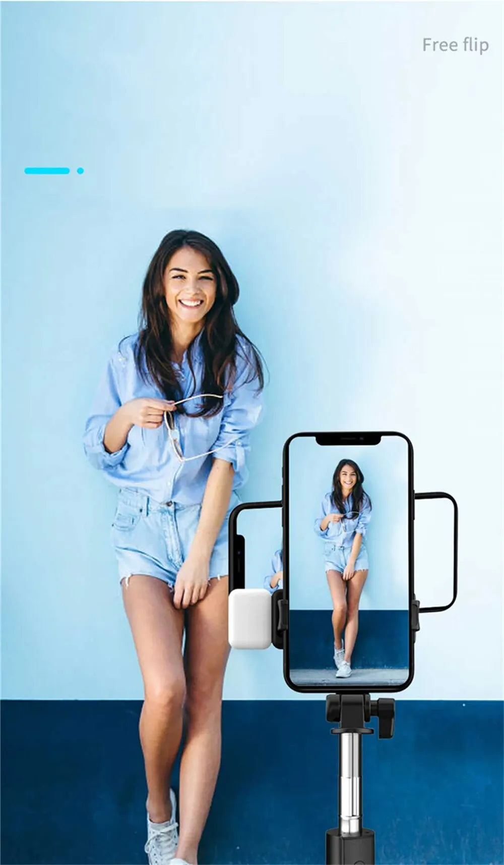 A woman is using an extendable Bluetooth selfie stick with a fill light to take a mirror selfie.