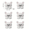 A set of cute white cartoon bear desk cable organizers in various sizes and styles.
