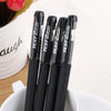 A bulk pack of black gel ink pens is shown standing upright on a white surface.