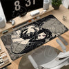 A gaming mouse pad featuring a dark illustration of characters and skulls, placed on a wooden desk.