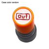 A rubber stamp with an orange handle and a white pad featuring the text Out in a meme face design.