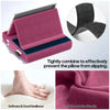 A pink foldable tablet pillow stand with a soft fabric cover and blue lining, designed to prevent pillows from slipping.