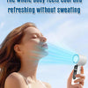A woman is using a portable semiconductor cooling fan to feel cool and refreshing without sweating.