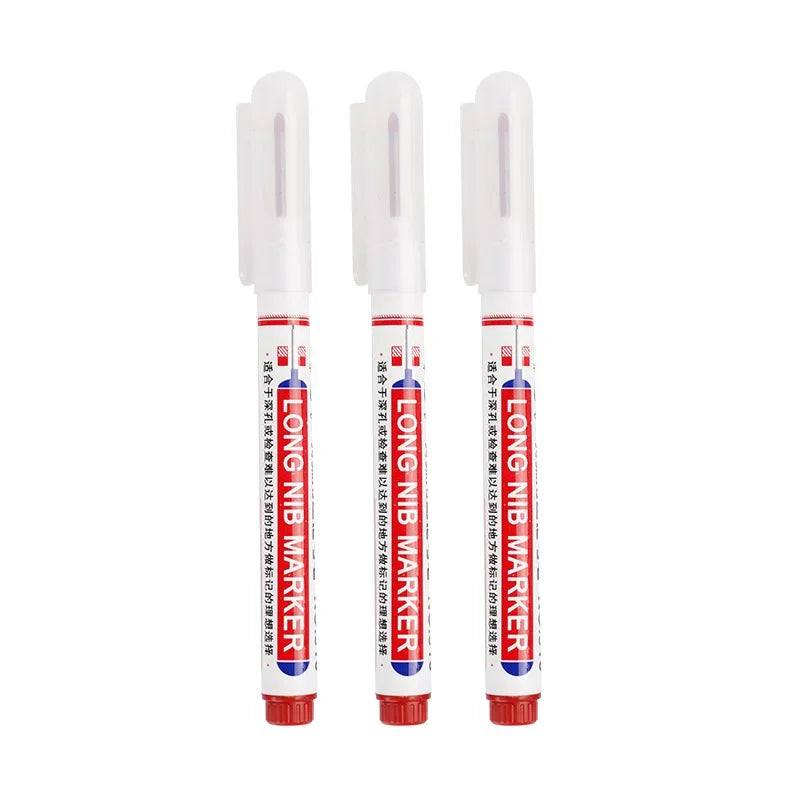 Three white permanent paint marker pens with clear tips are shown side by side.