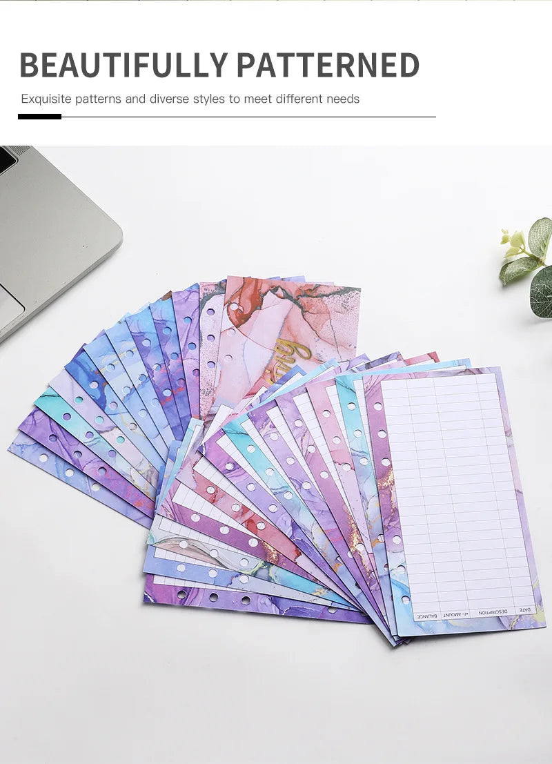A stack of beautifully patterned A6 budget planner binders with envelope pockets and expense sheets