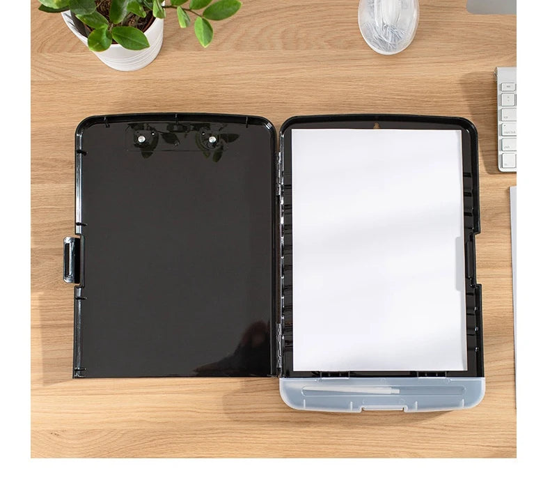 A black A4 waterproof file box with a writing board and pen slot is shown on a wooden table.