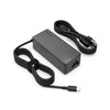 A black 65W USB-C laptop charger adapter with a coiled cable is shown on a white background.