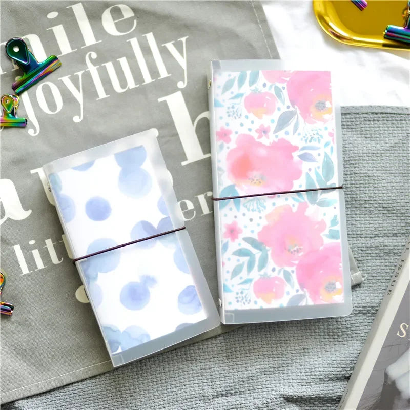 A clear PVC cover for a standard travelers notebook featuring a floral pattern on the inside.