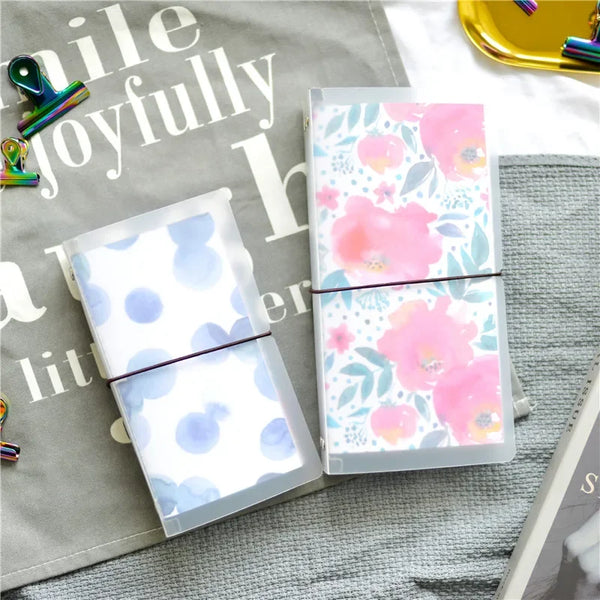 A clear PVC cover for a standard travelers notebook featuring a floral pattern on the inside.