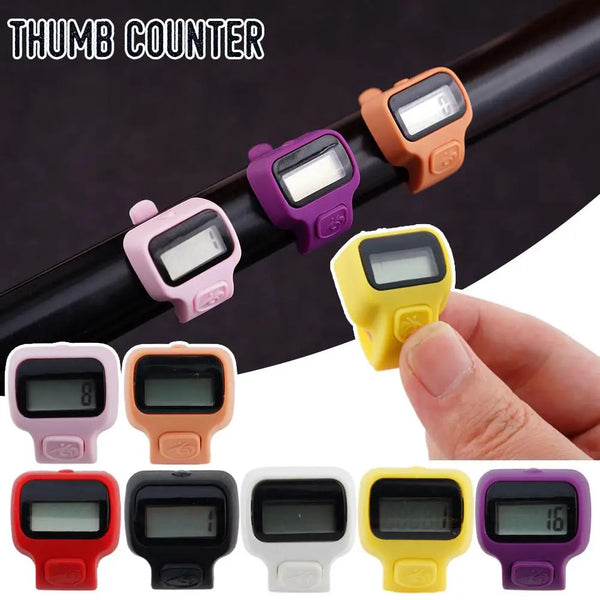 A collection of various colored thumb counter digital clickers shown on a dark surface.