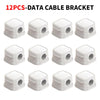 A set of twelve white plastic data cable brackets or clips for organizing wires.