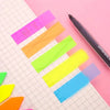 A collection of fluorescent PET sticky notes in various colors, including pink, orange, green, and blue, laid out on a grid p