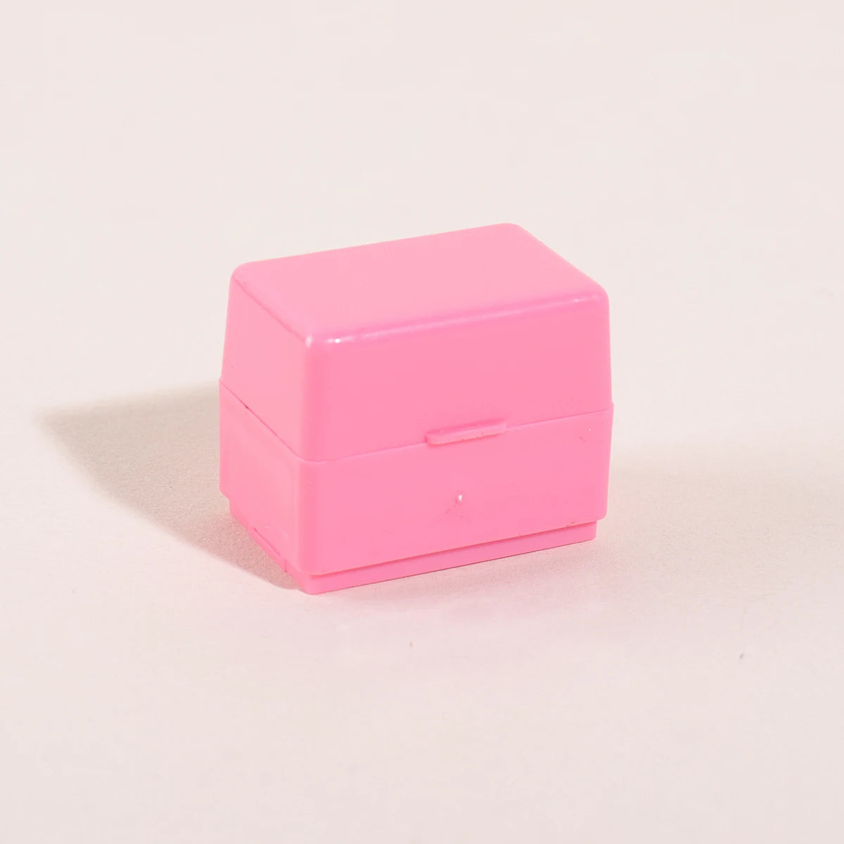 A pink privacy protection roller stamp box with a lid, shown against a light background.