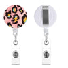 A silver retractable badge holder with a pink leopard print charm.