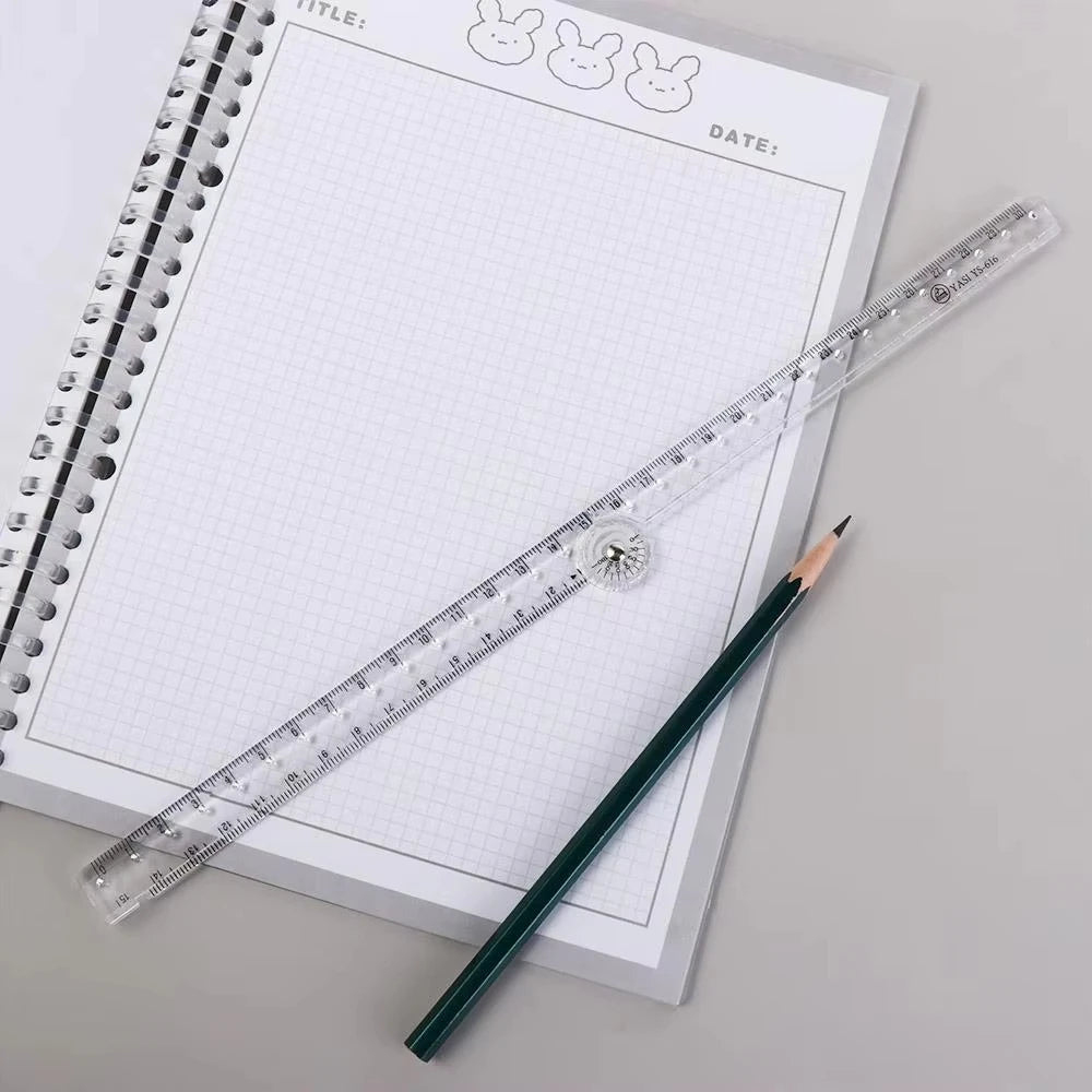 A transparent folding ruler and a pencil are placed on a spiral-bound notebook page.