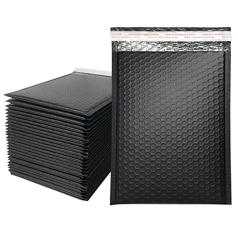 A stack of black padded bubble mailers with self-seal closures.