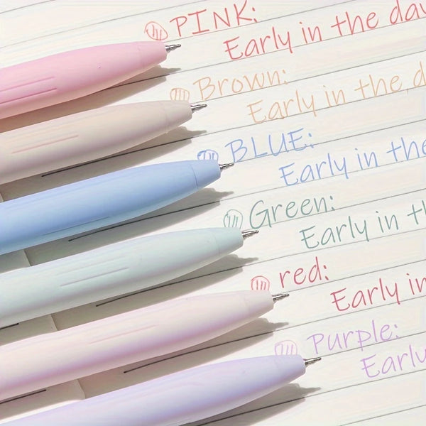 A collection of six pastel gel pens in pink, brown, blue, green, white, and purple are lined up on a sheet of paper.