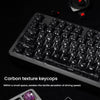 Close-up of carbon fiber textured keycaps on a mechanical keyboard and a separate set of keycaps.