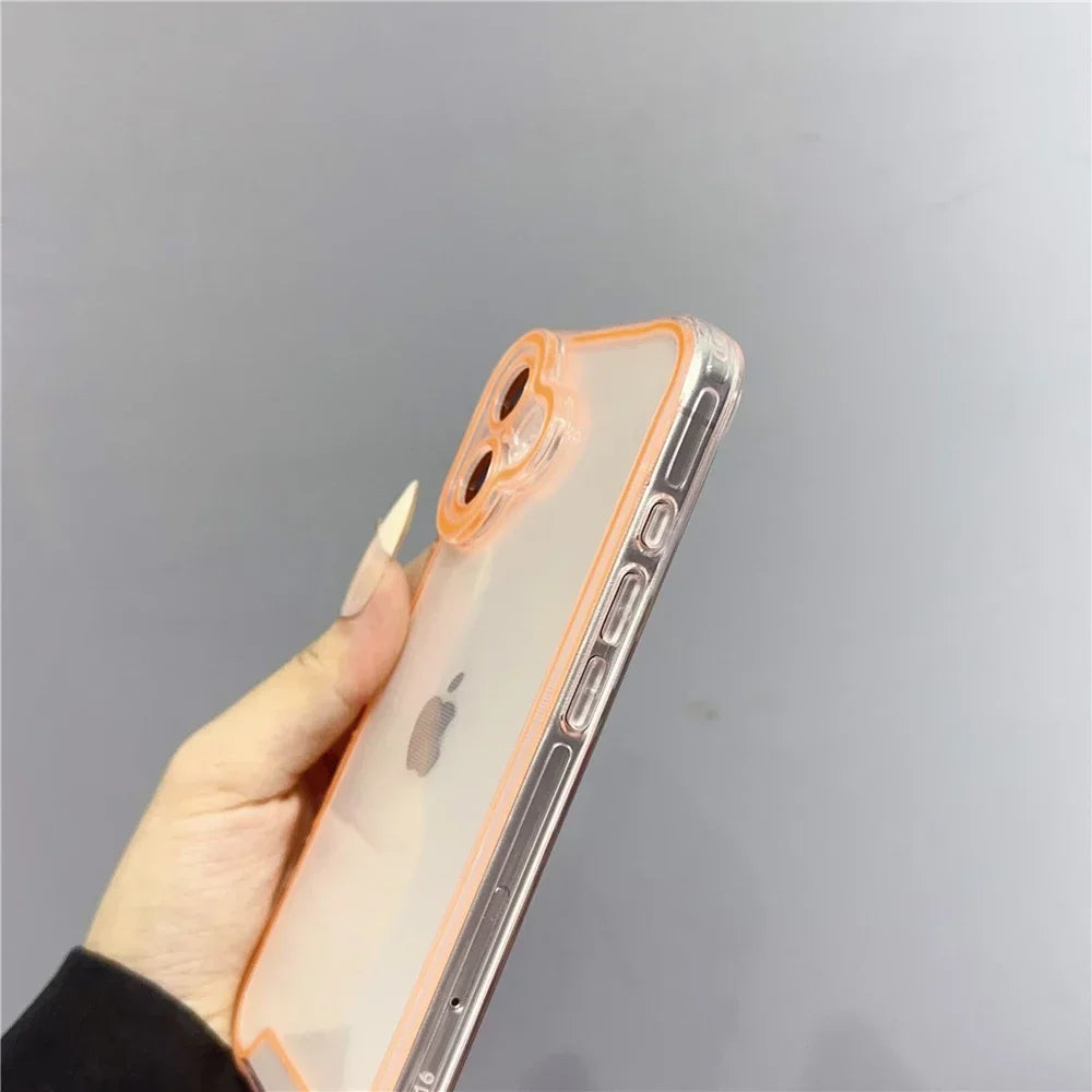 A hand holds a clear phone case with an orange rim on an iPhone, showing the back design.