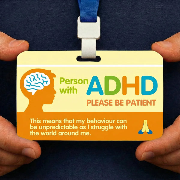 A yellow awareness card for a person with ADHD attached to a blue lanyard, showing a brain silhouette.