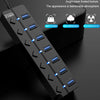 A black ABS material 7-port USB 3.0 hub extender with blue LED lights is shown on a dark surface.