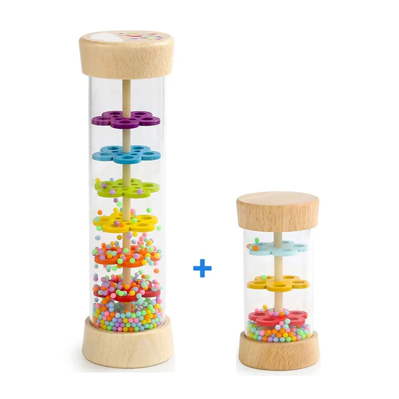 A wooden rain sound tube musical instrument with colorful plastic drops inside.